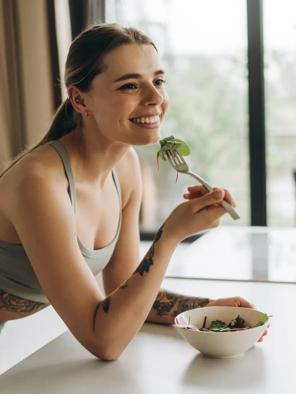 Woman eating in kitchen