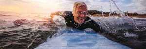 Man Surfing after Tampa Chiropractor Appointment Driven Fit